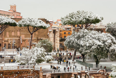 Rome, Italy, February 26, 2018: Romans and tourists visit Imperial Fora Avenue covered with snowのeditorial素材