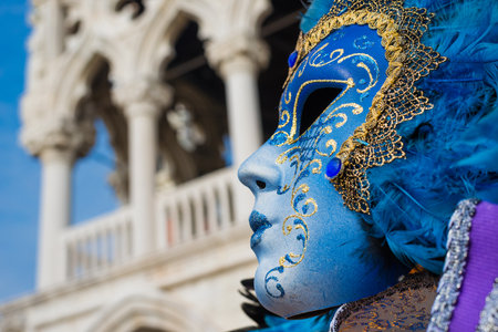 Venice, Italy, February 8, 2018: Carnival in Venice. A beautiful Venetian mask with Doge Palaceのeditorial素材
