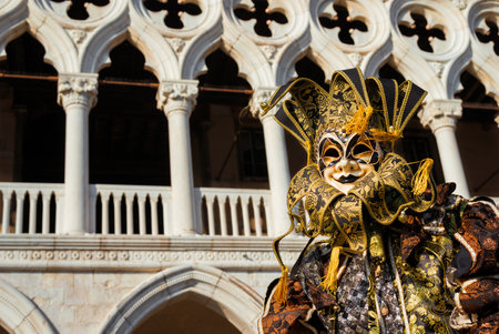 Venice, Italy, February 10, 2018: Carnival in Venice. Beautiful venetian masks with jester cap, in front of Doge Palaceのeditorial素材