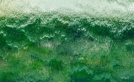 Wall of falling water on green and white background