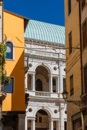 Wonderful Basilica Palladiana renaissance arches (16th-17th century), seen form Vicenza historic center narrow streetのeditorial素材