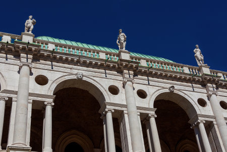 Wonderful Basilica Palladiana marble arches and statues (16th-17th century) in Vicenza with blue sky, designed by the famous renaissance architect Andrea Palladioのeditorial素材