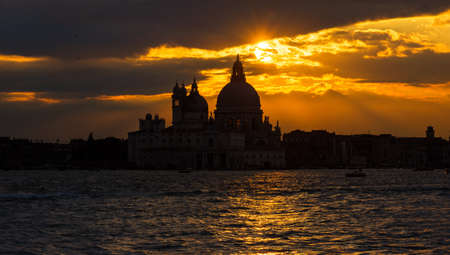 Beautiful sunset over Venice Lagoon and Saint Mary of the Health Basilicaの写真素材