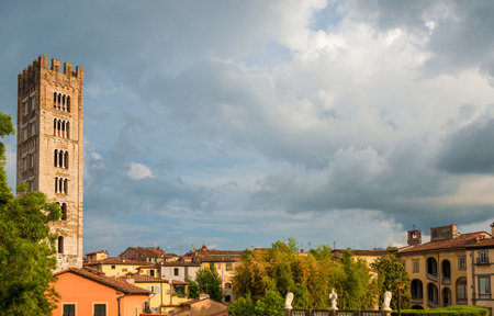 Visiting Lucca. Beautiful clouds over the old historic center with St Fridanius belfry, Guinigi Tower and Pfanner Palaceのeditorial素材