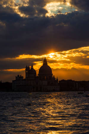 Beautiful sunset over Venice Lagoon and Saint Mary of the Health Basilicaの写真素材