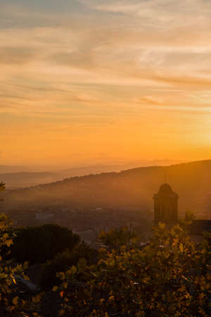Beautiful sunset sky with evening haze over Umbria countryside seen from the city of Perugiaの写真素材