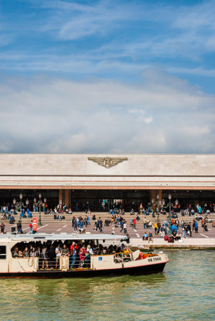 Public transport in Venice. Venezia Santa Lucia railway station and Vaporetto (ferry) with tourists seen from Grand Canalのeditorial素材