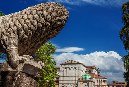 Ancient lion statue looks at Lucca medieval historic centerのeditorial素材