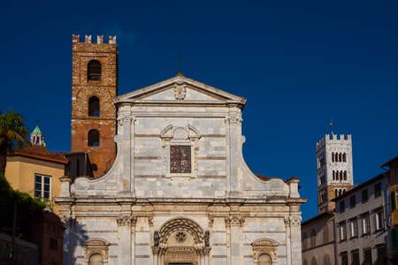 Old medieval churches in Lucca historic center with ancient bell towersの写真素材