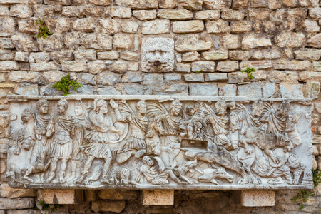 Old fountain with ancient roman reliefs in Spoleto Cathedral Squareのeditorial素材