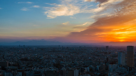 Sunset view of city endless suburbs of Meguro, Setagaya and Kawasaki with the  iconic Mount Fuji wrapped in evening mist, from Ebisuのeditorial素材