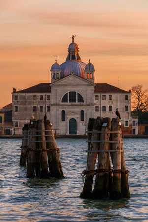 Sunset view of the late renaissance Zitelle Church on Giudecca Island in Venice Lagoon through venetian characteristic "bricola" polesのeditorial素材