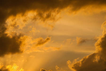 Sunset sky with golden clouds as backgroundの写真素材