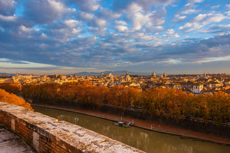 Autumn and foliage in Rome. Panoramic view of city historic center ancient skyline at sunset with beautiful autumnal leavesの写真素材