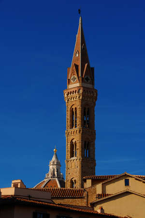 Medieval bell tower and St Mary of the Flower famous dome rise above Florence historic center roofsの写真素材