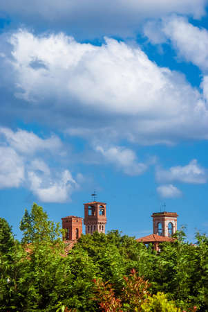 Lucca charming historical center skyline with beautiful clouds and medieval towers rises above surrounding anciet walls park treesの写真素材