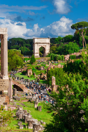 ROME, ITALY - MAY 19, 2019: Sightseeing in Rome. Tourists visit Roman Forum ancient ruins with the famous Arch of Titusのeditorial素材