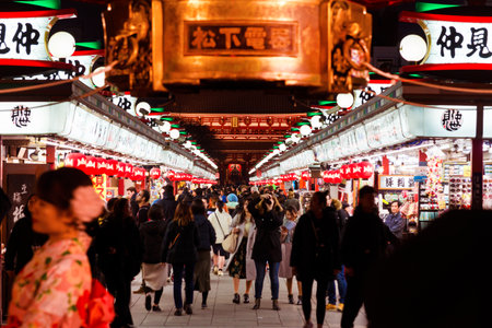 TOKYO, JAPAN - FEBRUARY 20, 2019: Tourists flocking to Senso-ji Temple and Nakamise shopping street in Asakusa district at nightのeditorial素材
