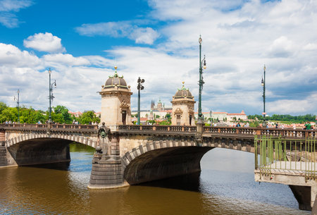 PRAGUE, CZECH REPUBLIC - JULY 16, 2022: People walk across the beautiful Legion Bridge with Prague Castle in the backgroundのeditorial素材