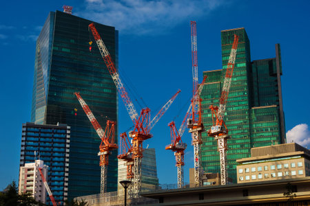 TOKYO, JAPAN - OCTOBER 12, 2023: Construction industry of Japan. Cranes at work in Roppongi, a...