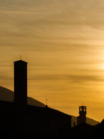 Lucca old skyline at sunset with medieval towers silhouette and golden cloudsの写真素材