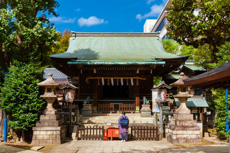 TOKYO, JAPAN - OCTOBER 18, 2023: Religion and spirituality in Japan. Praying in front of Gojoten Shrine in Ueno Parkのeditorial素材
