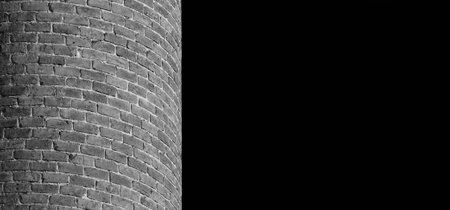 Curved brick wall as background (Black and white with copy space)の写真素材