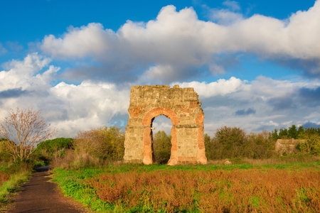 Ancient Roman aqueduct beautiful arches ruins in Rome with beautiful cloudsの写真素材