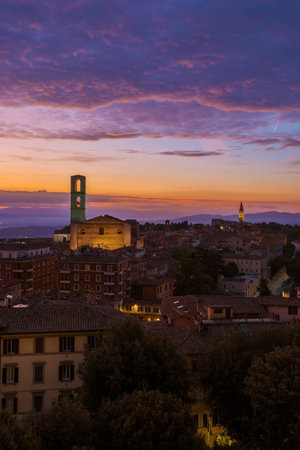 Beautiful purple clouds over Perugia historical center just before dawnの写真素材