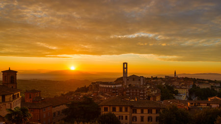 Beautiful dawn sky with morning haze over the old city of Perugia, with medieval bell towers and Umbria countryside in the backgroundの写真素材