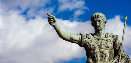 Caesar Augustus, the first emperor of Rome. Bronze monument (replica) among clouds, along Imperial Fora Avenue, in the city centerの写真素材