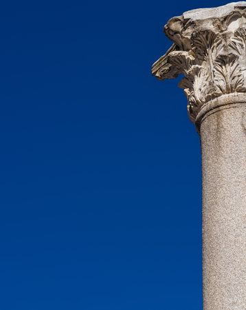 Classical architecture. Ancient roman column and capital (with blue sky and copy space)の写真素材