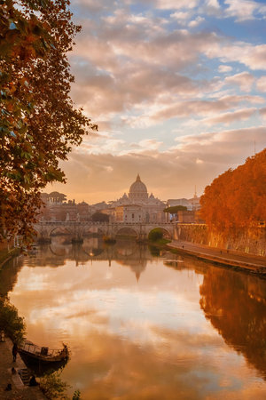 Autumn and foliage in Rome. Beautiful sycamore orange leaves along River Tiber in mist during sunsetの写真素材
