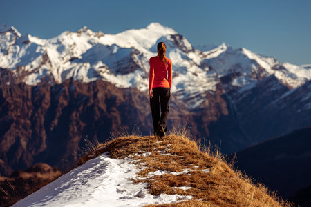 woman on top of a mountain observes the viewの写真素材