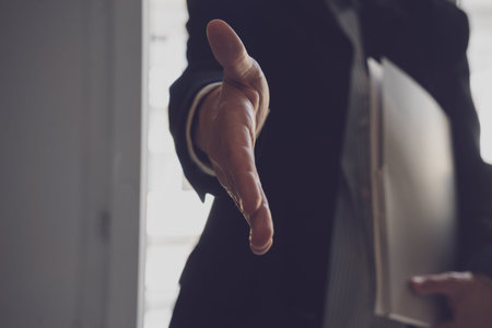 A young businesswoman extended her hand