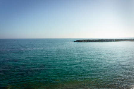 Mediterranean sea with breakwater at the bottomの写真素材