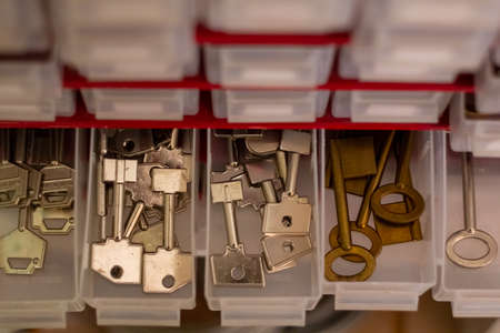 Different types of vintage keys to duplicate in drawers. Keyblanks for cutting.の写真素材