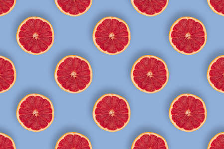 Sweet and juicy grapefruits pattern on blue backgroundの写真素材