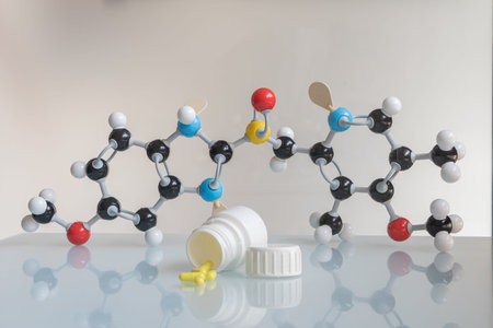 Omeprazole pills and pill bottle with omeprazole chemical formula made by molecular model in the...