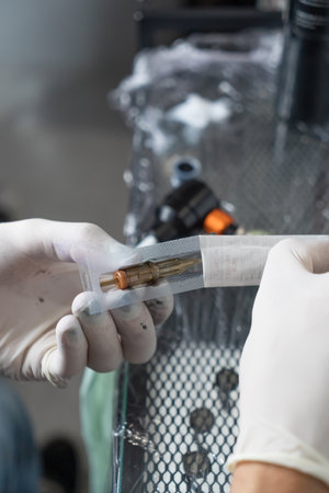 close-up of hands of a technician in gloves holding a scalpelの写真素材