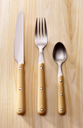 Wooden cutlery on a wooden background