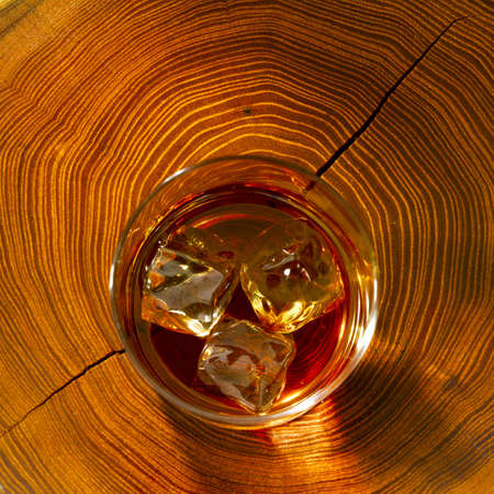 Whiskey on the rocks and on woodの写真素材