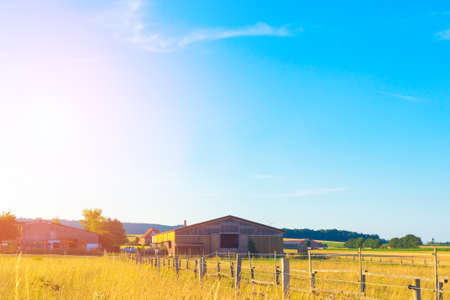 Long barn on the background of a fieldの写真素材