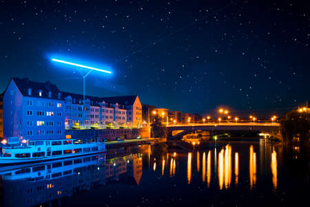 houses by the river in the city at nightの写真素材