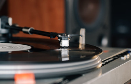 Close-up of a cartridge head on a vinyl record, analog retro music, vinyl disc collecting, vintage...