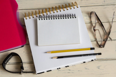 pen notepad with blank sheets near glasses and documents.