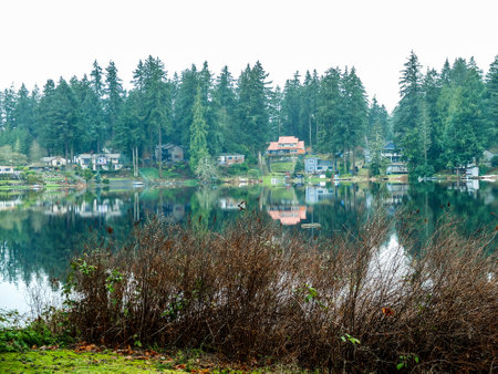 Autumn, reflection of trees and house in the lake. Landscape for backgroundの写真素材