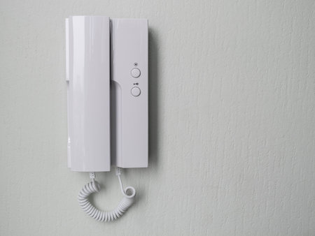 intercom receiver on a light-colored wall