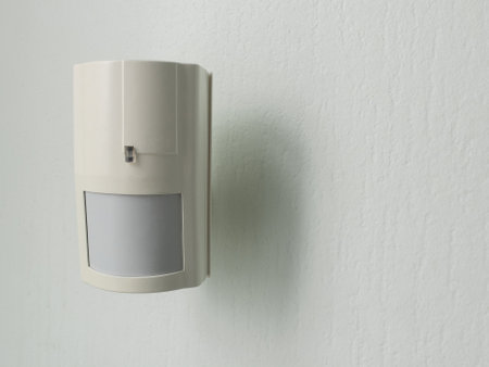 Modern motion sensor on wall indoorsの写真素材