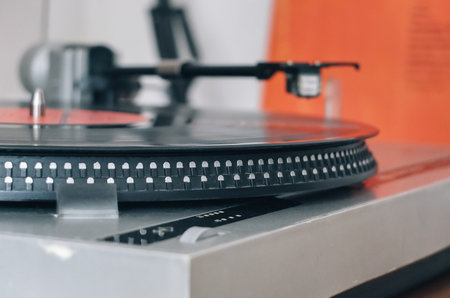 Close-up of a cartridge head on a vinyl record, analog retro music, vinyl disc collecting, vintage...